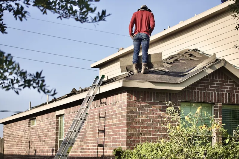 Professional roofer working on a residential roof in My Ladys Manor Estates